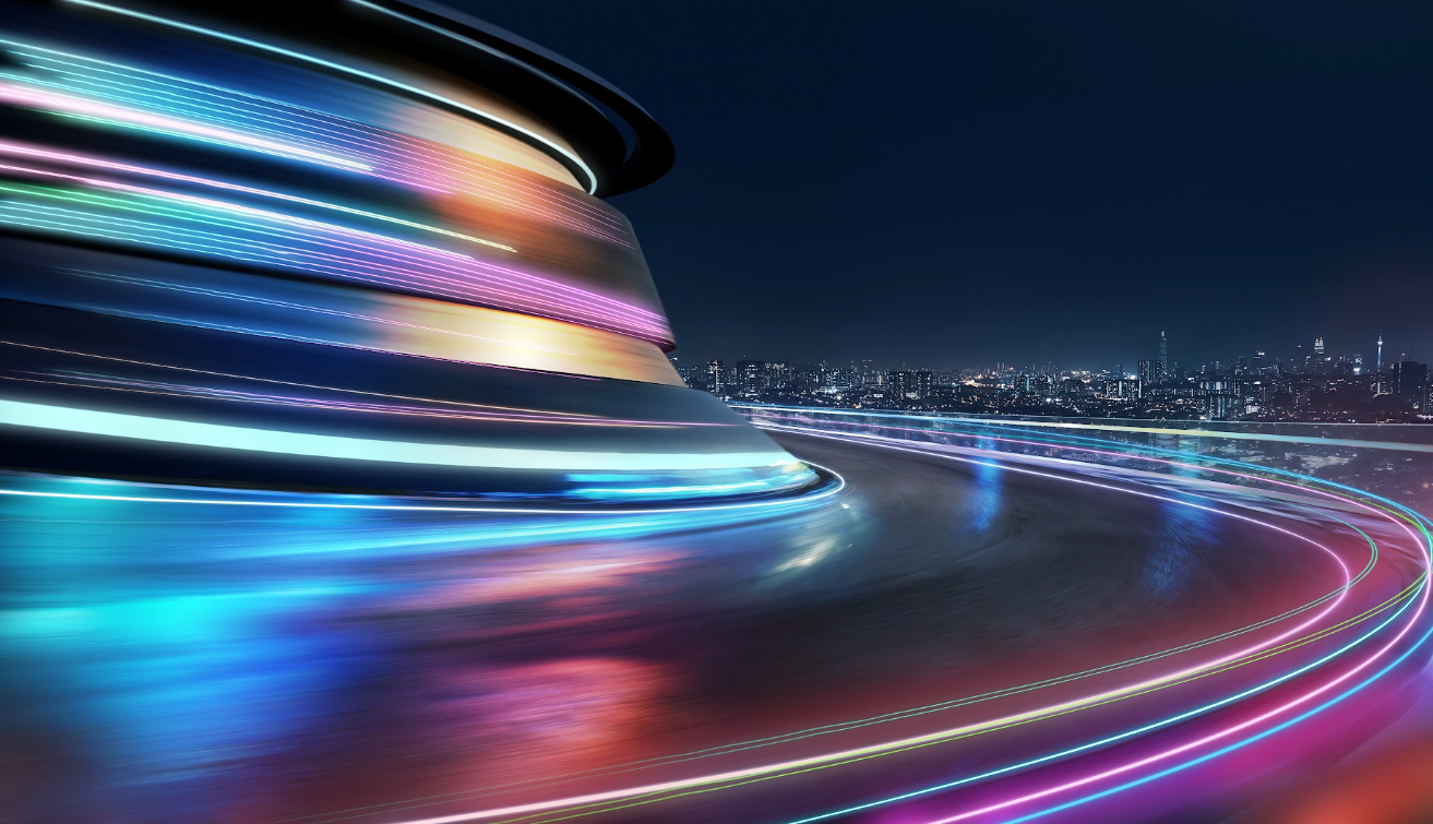Curved road with neon light trails and a futuristic building against a night city skyline